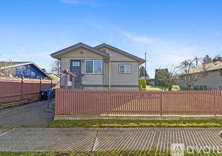 A house with a brown fence in front of it.