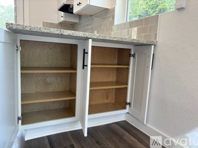 A kitchen cabinet with two open shelves.