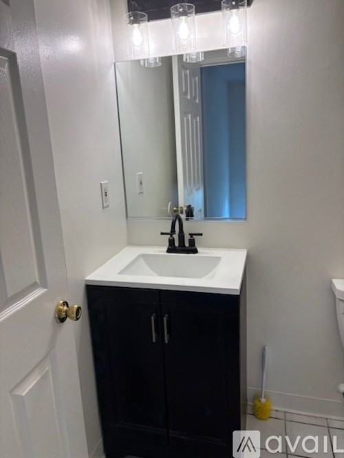 A bathroom with a sink and mirror.
