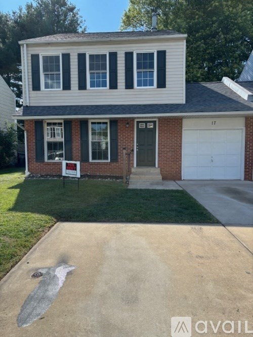 A house with a garage and a driveway in front.