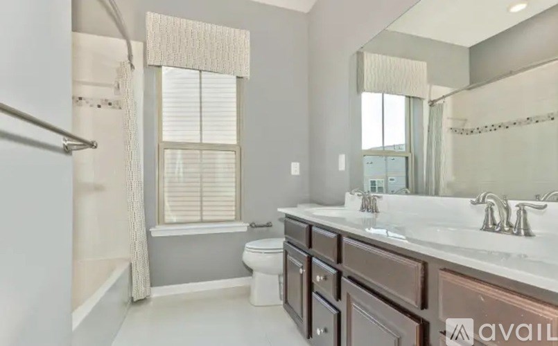 A bathroom with a toilet, sink, and bathtub.