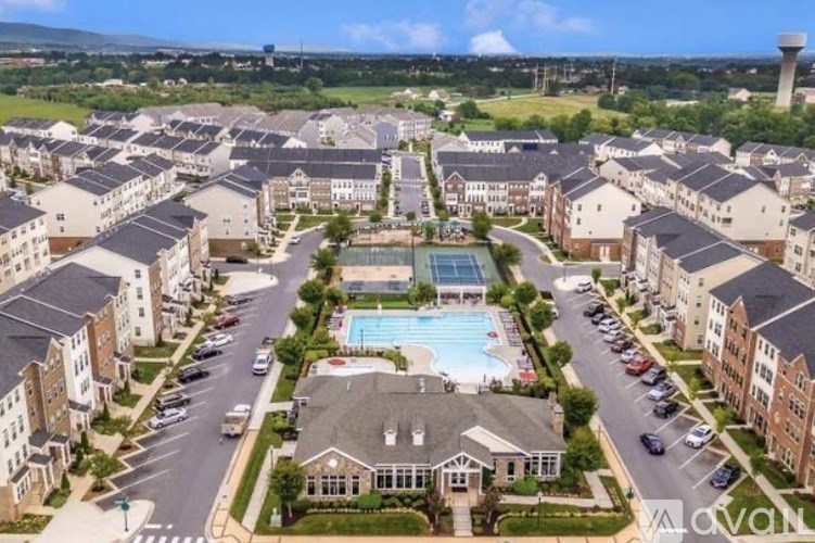 A large apartment complex with a pool in the middle.