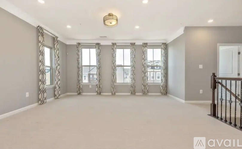 A spacious room with a balcony and a view of the city.