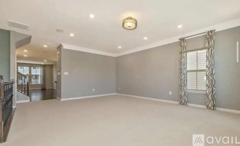 A spacious room with a large window and a view of the outside.