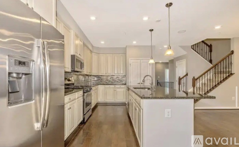 A modern kitchen with stainless steel appliances and a central island.