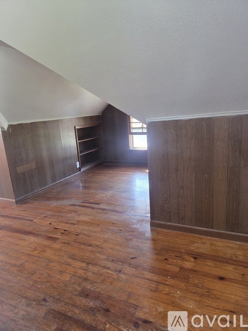 A room with wooden floors and a window.