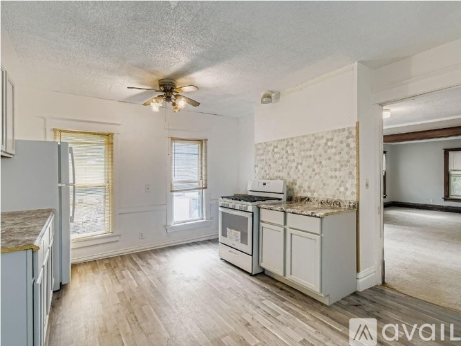 A kitchen with a refrigerator, stove, and oven.