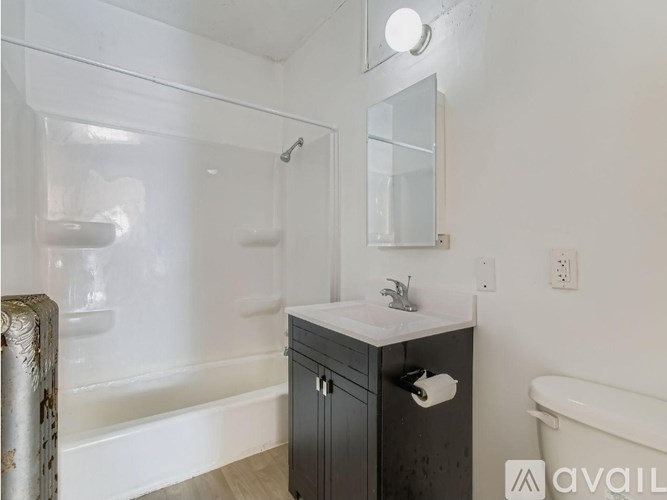 A bathroom with a glass shower enclosure and a white sink vanity.