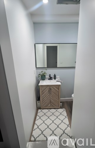 A bathroom with a sink and mirror.