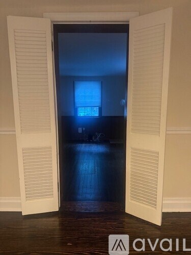 A room with a dark floor and a light blue wall.