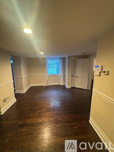 A room with wooden floors and white walls.