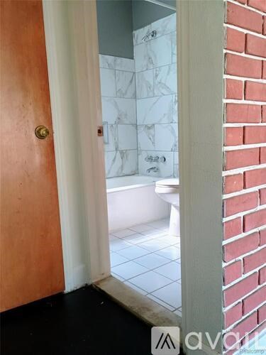 A bathroom with a toilet and a shower.