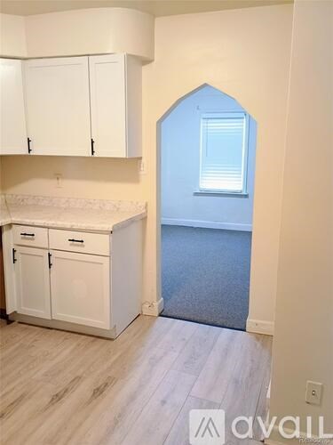 A kitchen with white cabinets and a countertop.