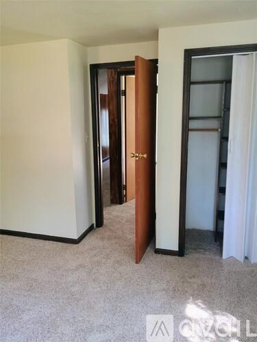 A room with a white door and a brown door.