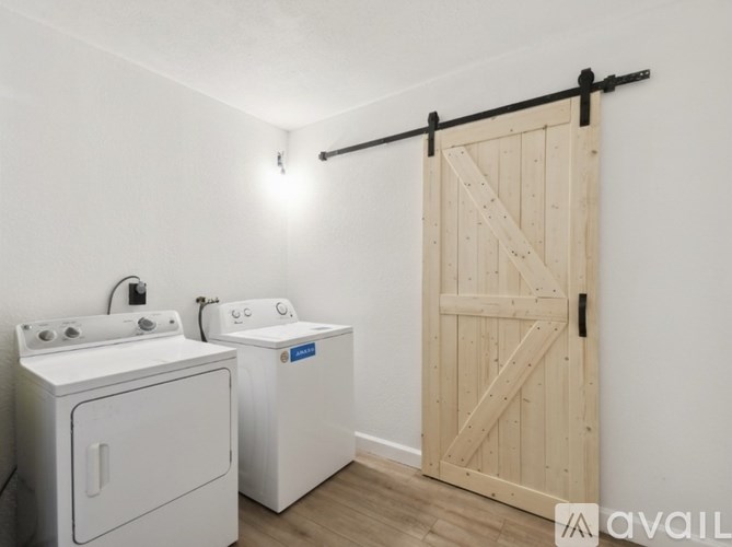 A white washing machine and dryer in a small laundry room.