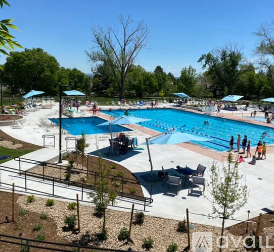 A pool area with people swimming and relaxing.