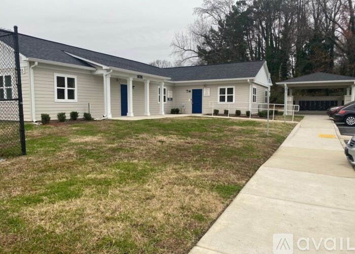 A small house with a blue door is available for rent.
