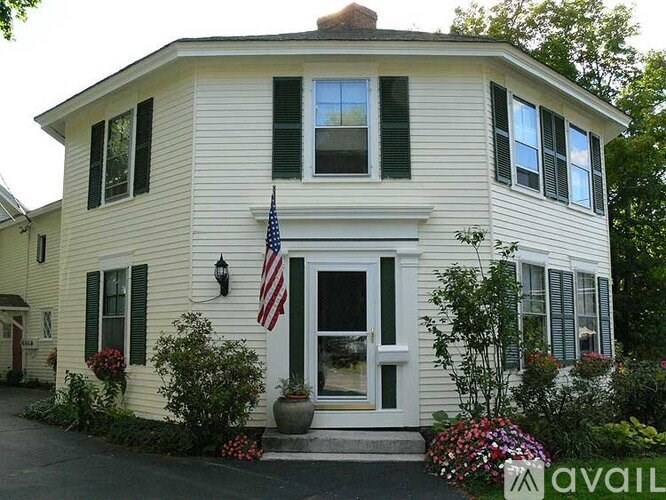 A house with a flag on the front porch.