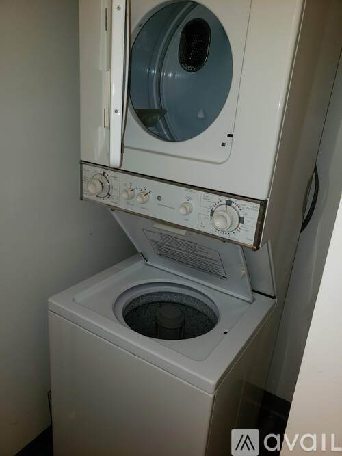 A white washing machine with the door open and control panel in front.