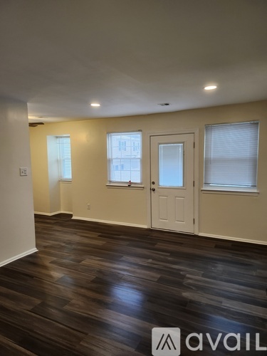 A room with wooden floors and white walls.