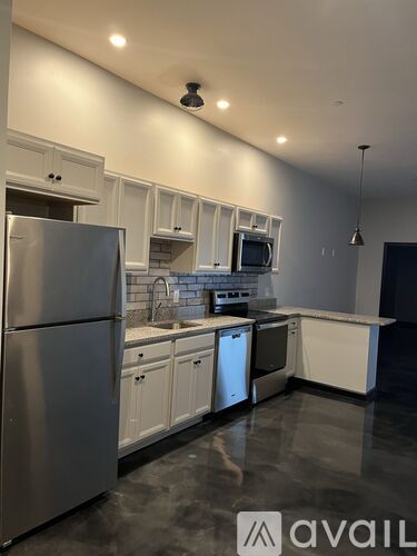 A modern kitchen with stainless steel appliances and white cabinets.
