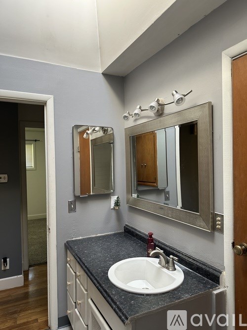 A bathroom with a sink and mirror.
