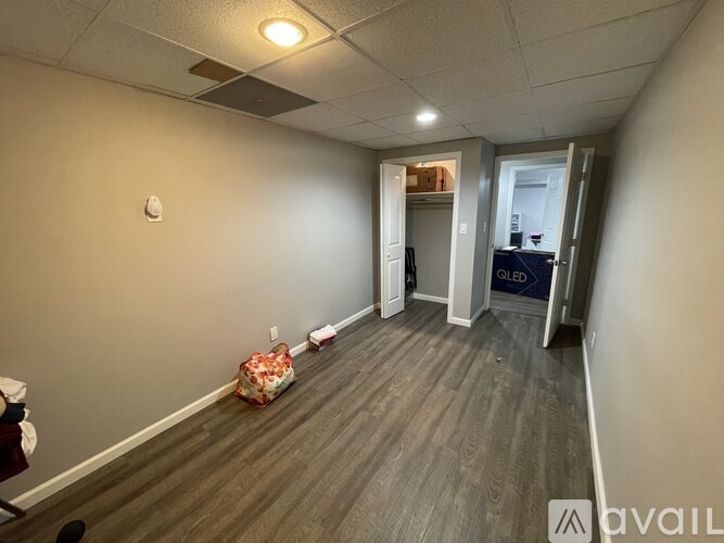 A room with a carpeted floor and a white door.