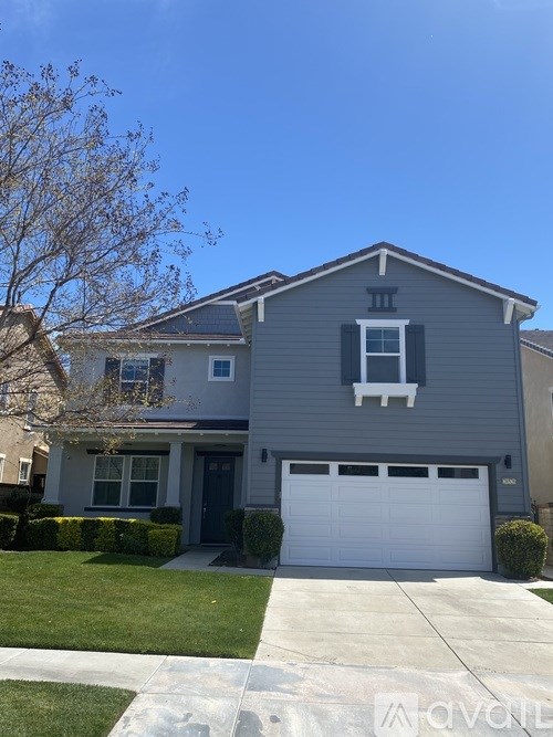 A grey house with a white garage door.