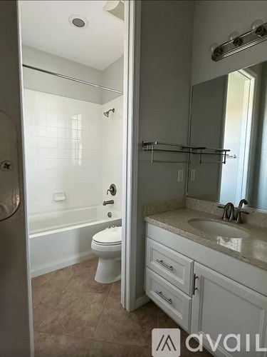 A bathroom with a toilet, sink, and bathtub.