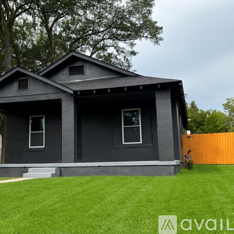 A house with a grey exterior and a brown fence.