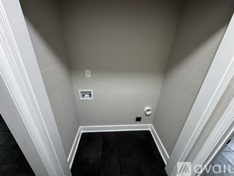 A small white square on the wall in a hallway.