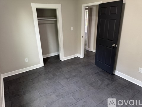 A room with a black door and a white doorway.