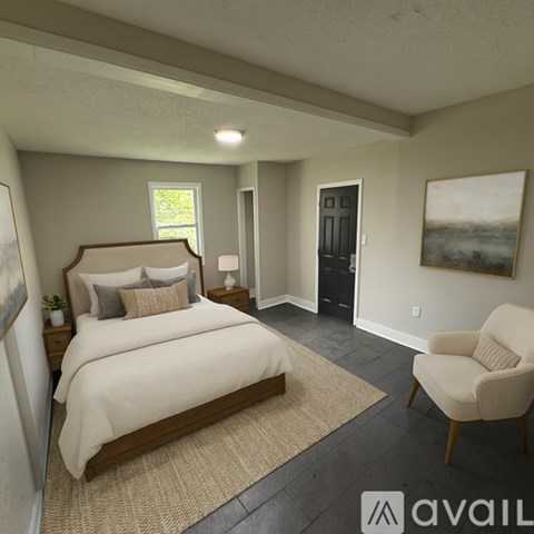 A bedroom with a large bed and a chair.