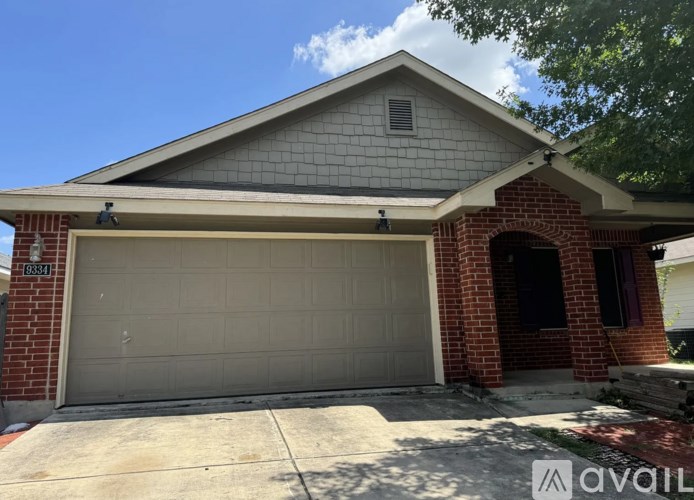 A house with a garage door and a brick chimney.