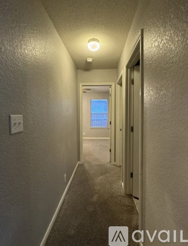 A long hallway with a door at the end.
