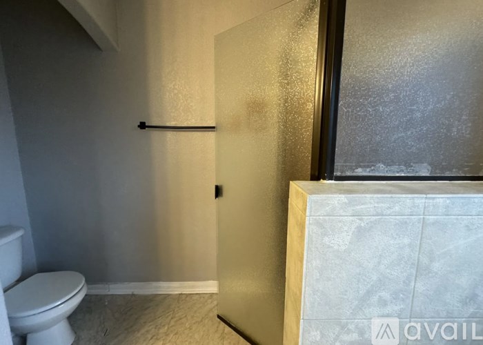 A bathroom with a toilet and a door.