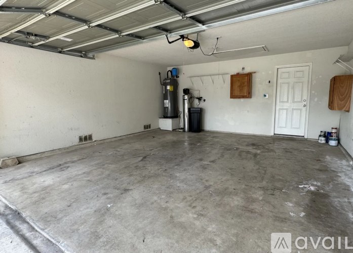 A spacious garage with a concrete floor and white walls.