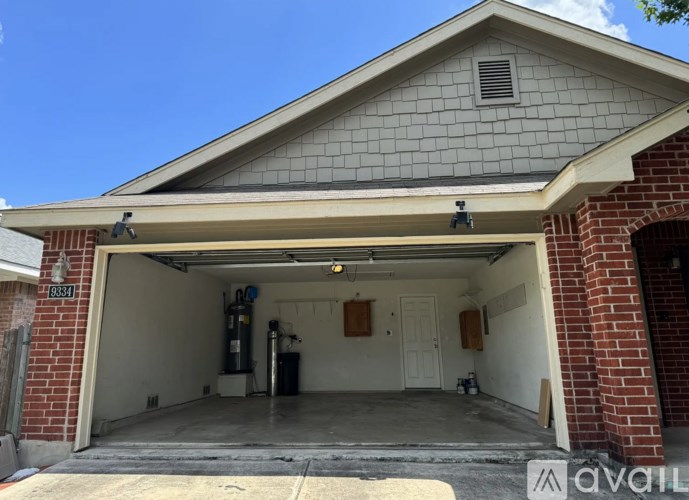 A garage with a brick wall and a white door is available for rent.