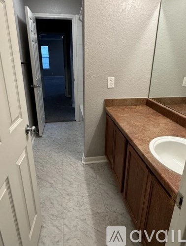 A bathroom with a sink and mirror.