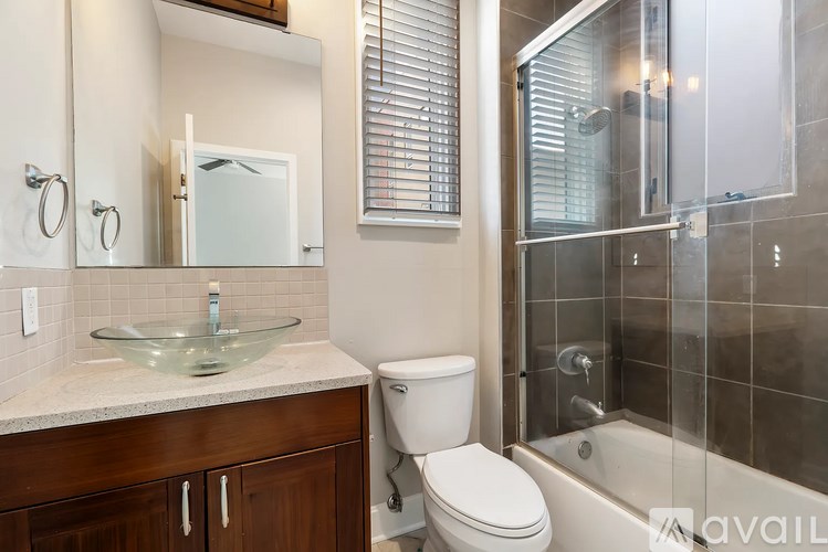 A bathroom with a toilet, sink, and shower.