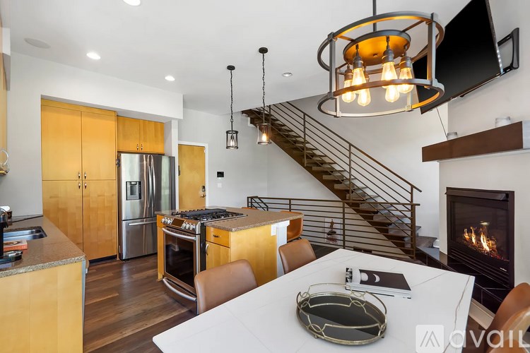 A modern kitchen with a stainless steel refrigerator and wooden cabinets.