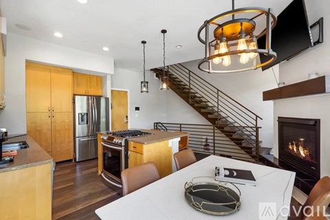A modern kitchen with a stainless steel refrigerator and wooden cabinets.