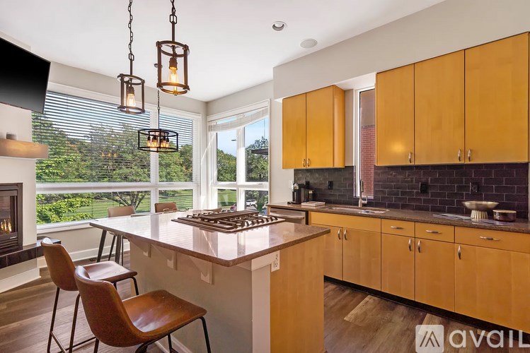 A kitchen with wooden cabinets and a large island.
