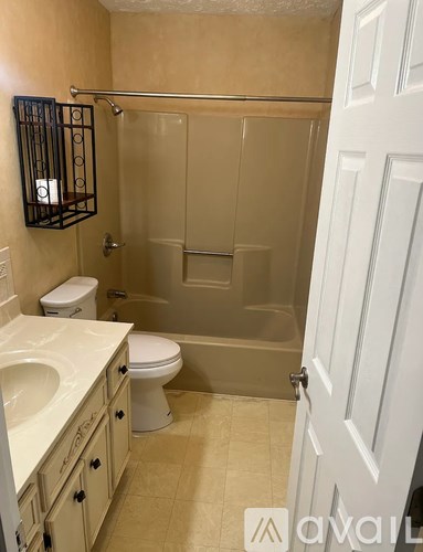 A bathroom with a toilet, sink, and bathtub.