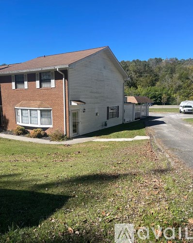 A house with a white garage door and a brown roof.