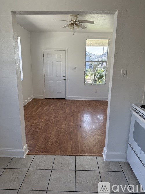 A room with a wooden floor and a ceiling fan.