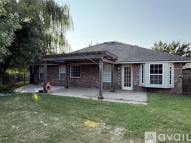 A house with a brick exterior and a covered patio area.