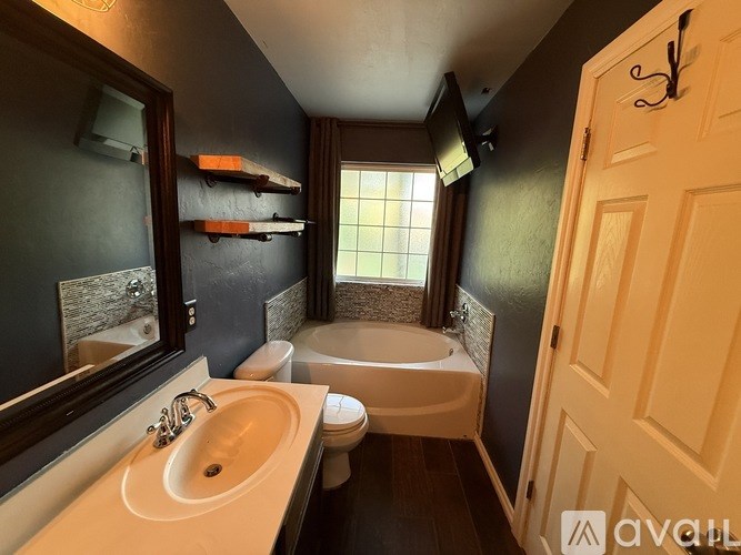 A bathroom with a sink, toilet, and bathtub.