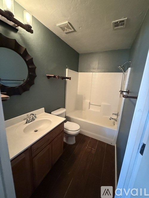 A bathroom with a white sink and a white toilet.