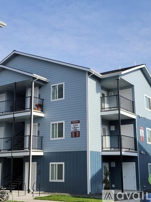 A blue apartment building with a sign that says "avani".